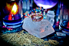 Ring on a crystal with mystical background
