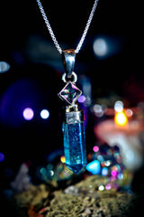 7 ARCHANGEL GENIES Djinn Amulet Crystal pendant necklace with a blurred bokeh background