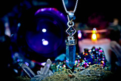 Crystal pendant necklace with a mystical background featuring crystals and lights. 7 ARCHANGEL GENIES Djinn Amulet