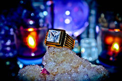 Gold ring with a large diamond on a crystal rock with a mystical background
