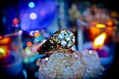Sparkling ring on a decorative stand with blurred colorful lights in the background